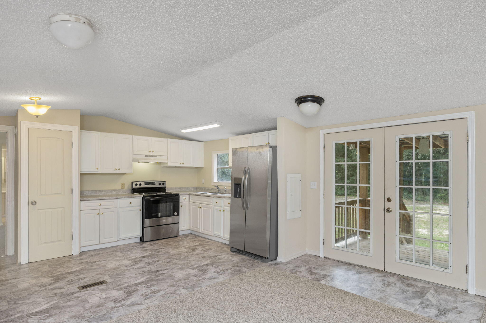 1108 Country Living Road Baker, FL 32531 - Photo 12 of 33 a kitchen with stainless steel appliances granite countertop a refrigerator oven stove and a sink with granite countertops