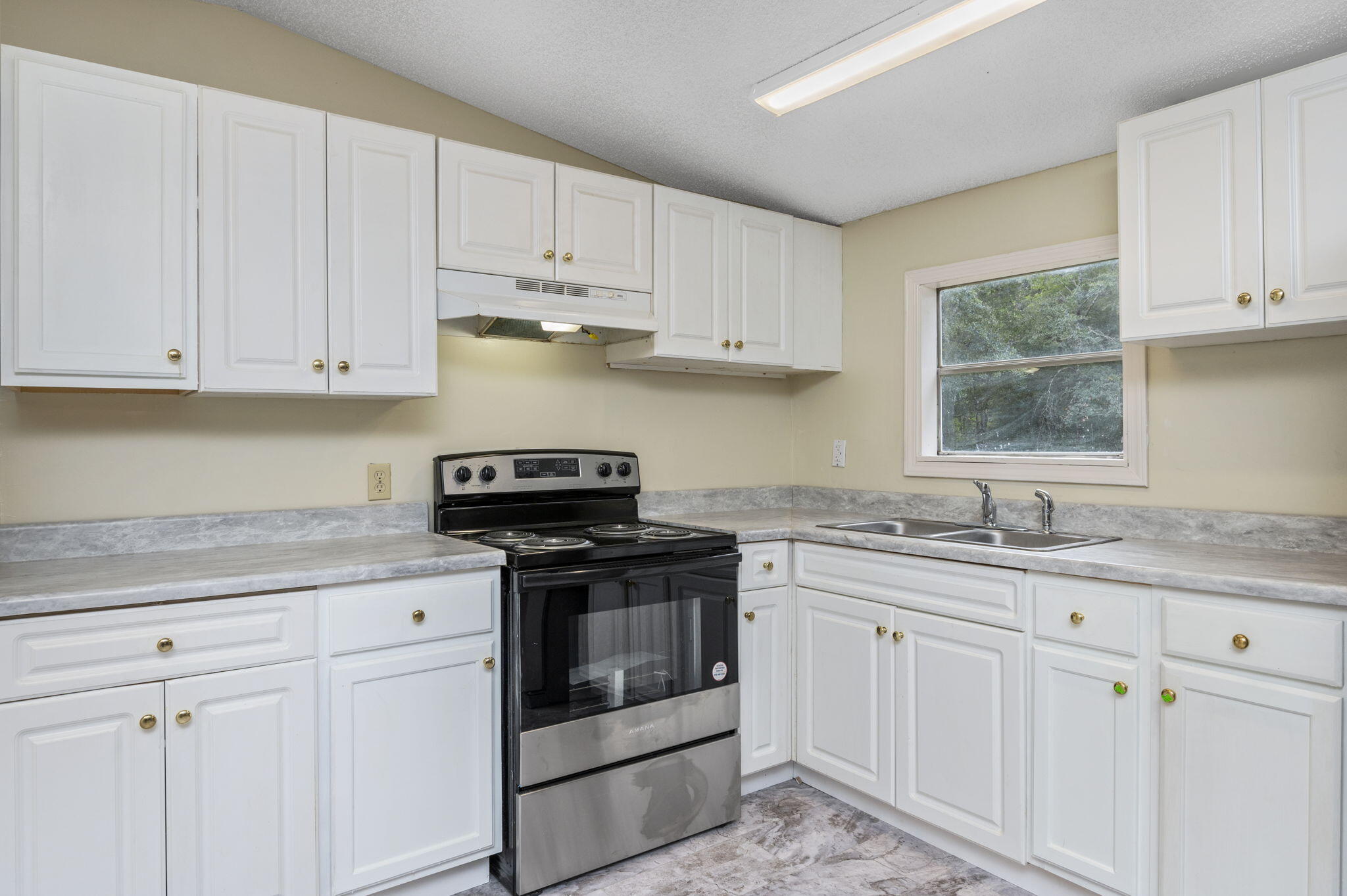 1108 Country Living Road Baker, FL 32531 - Photo 15 of 33 a kitchen with granite countertop white cabinets and white appliances