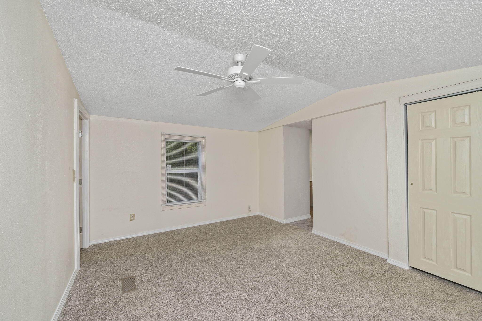 1108 Country Living Road Baker, FL 32531 - Photo 17 of 33 an empty room with a ceiling fan and a window