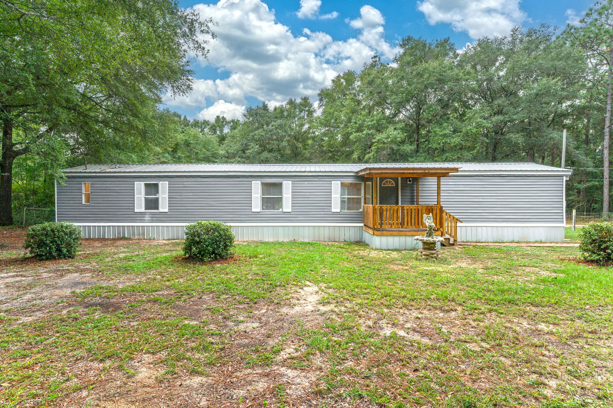 1108 Country Living Road Baker, FL 32531 - Photo 2 of 33 a view of a house with backyard and a tree