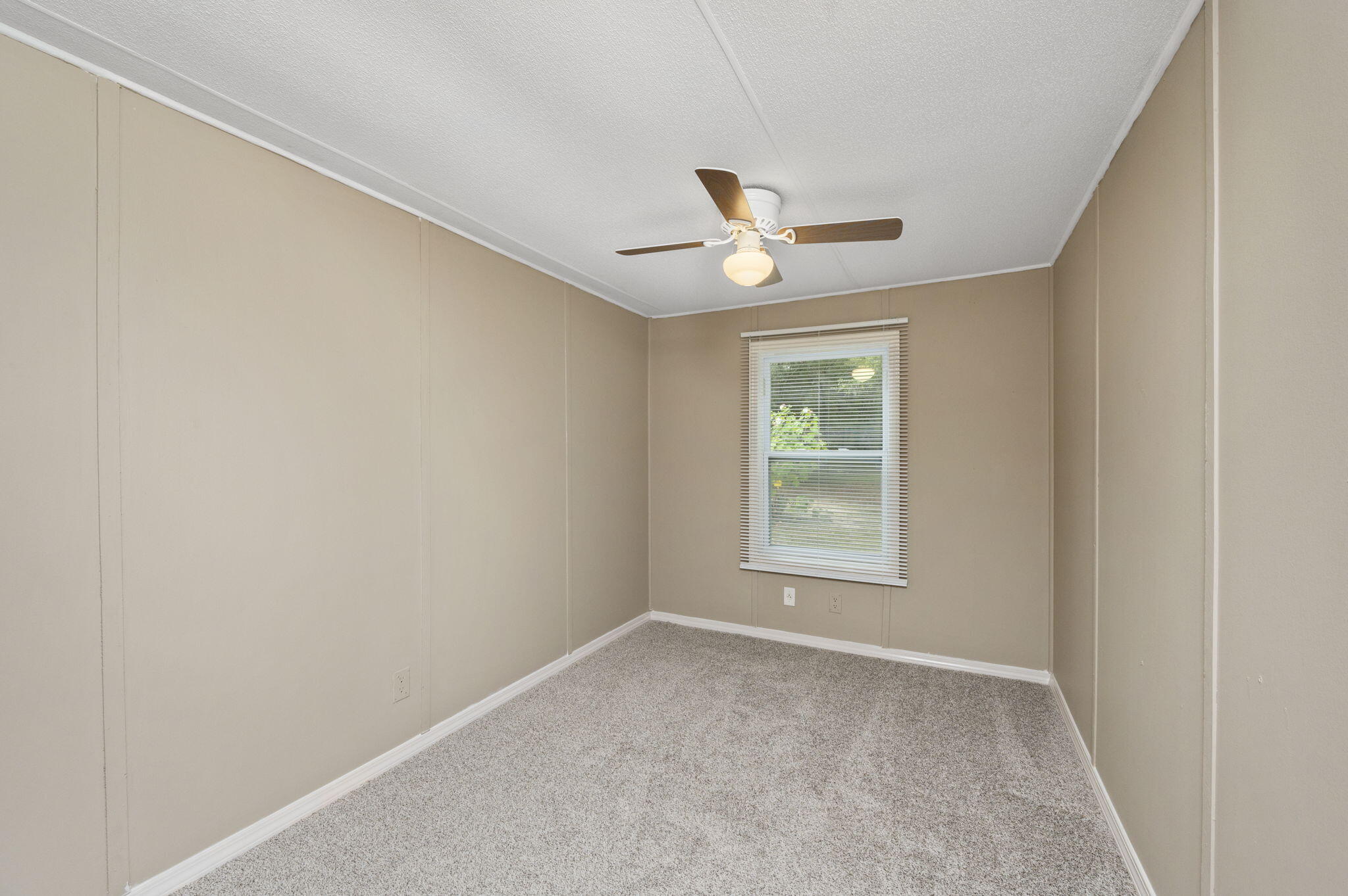 1108 Country Living Road Baker, FL 32531 - Photo 22 of 33 an empty room with a window and ceiling fan