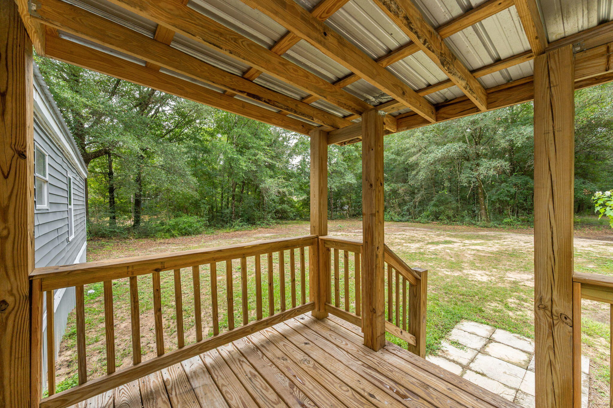 1108 Country Living Road Baker, FL 32531 - Photo 28 of 33 a view of a balcony with wooden floor