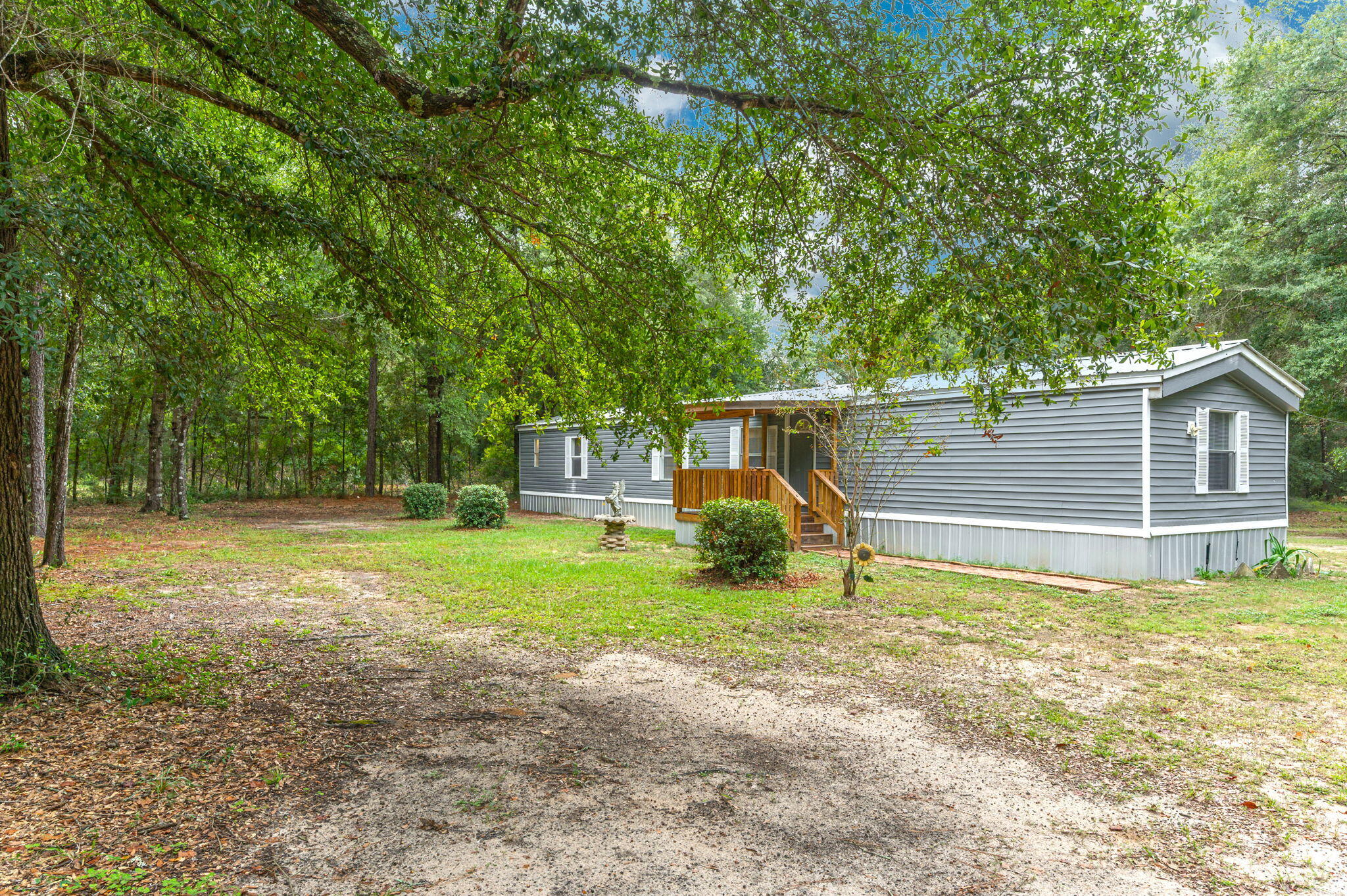 1108 Country Living Road Baker, FL 32531 - Photo 4 of 33 a view of a house with backyard and a tree