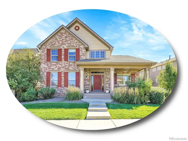 a view of a white house with large windows and a yard