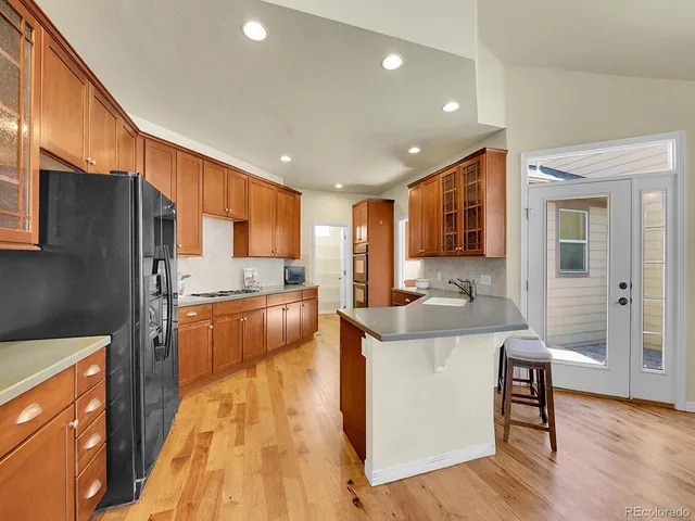 a large kitchen with stainless steel appliances kitchen island granite countertop a large counter top stainless steel appliances and cabinets