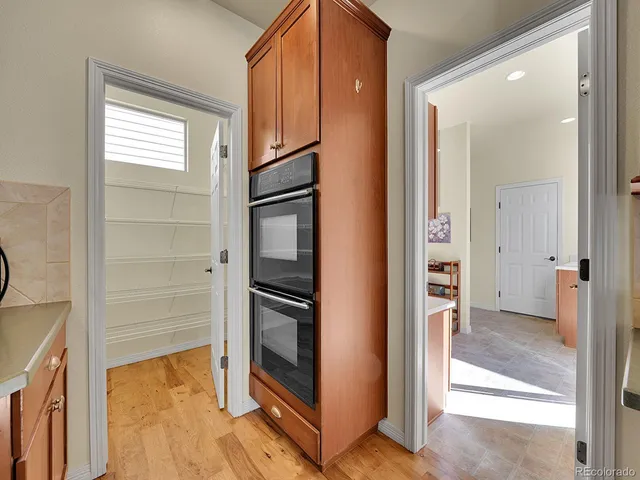a view of walk in closet with wooden floor