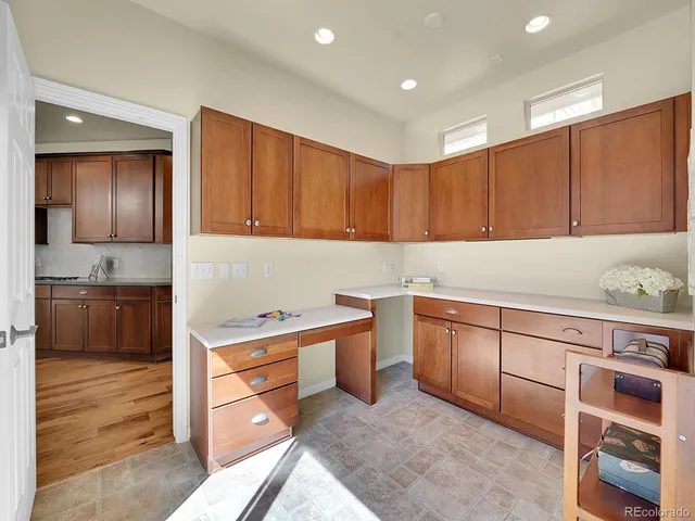 a kitchen with granite countertop a sink cabinets stainless steel appliances and a counter top space