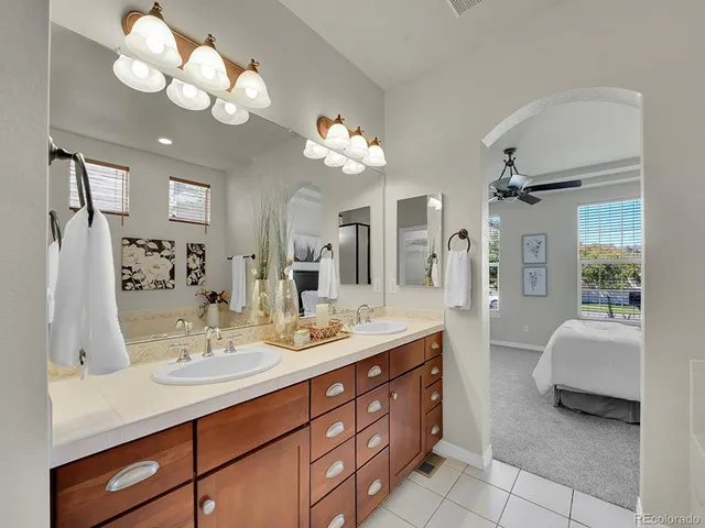 a spacious bathroom with a double vanity sink and a mirror