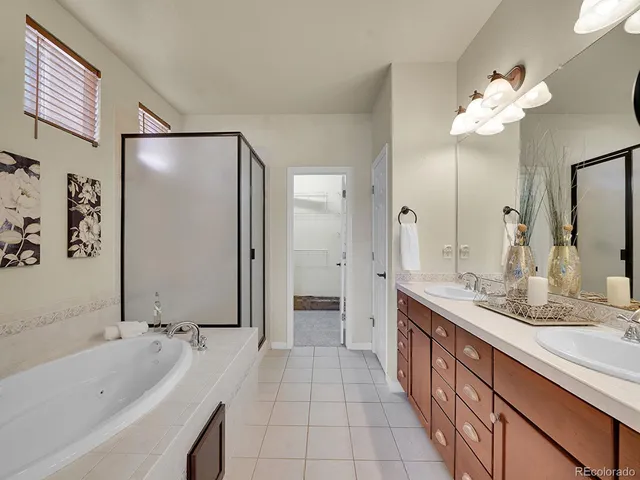 a spacious bathroom with a bathtub sink and mirror