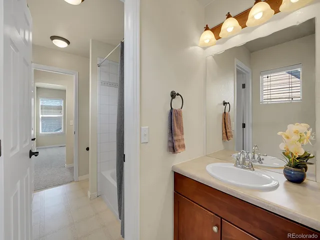a bathroom with a sink vanity granite and a mirror
