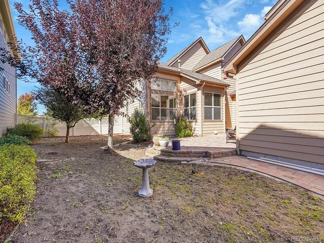 a backyard of a house with outdoor seating