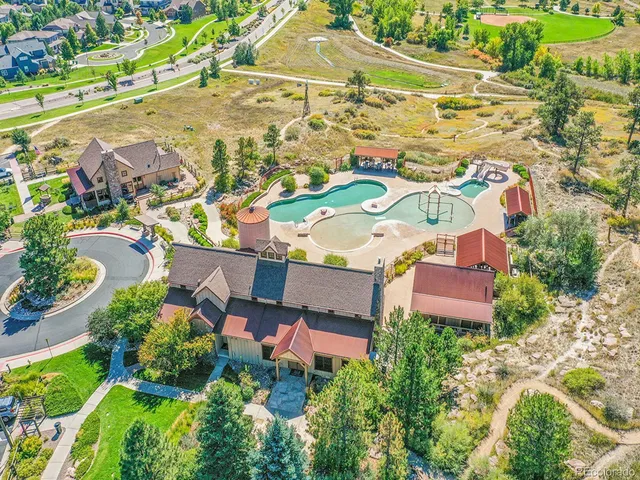 an aerial view of residential houses with outdoor space and street view
