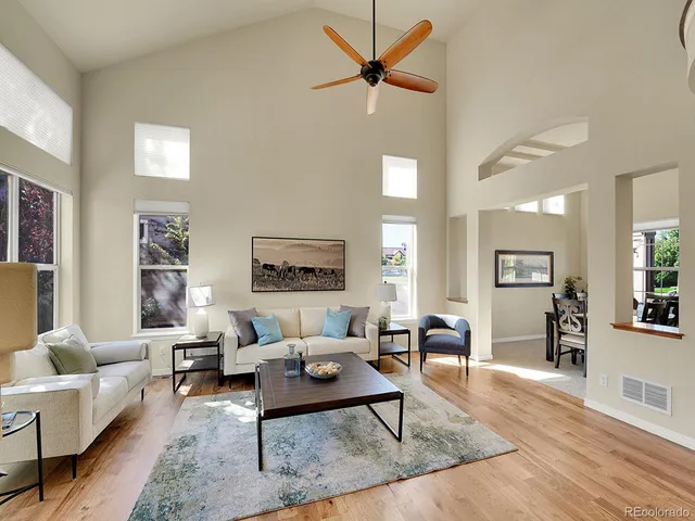 a living room with furniture and a wooden floor