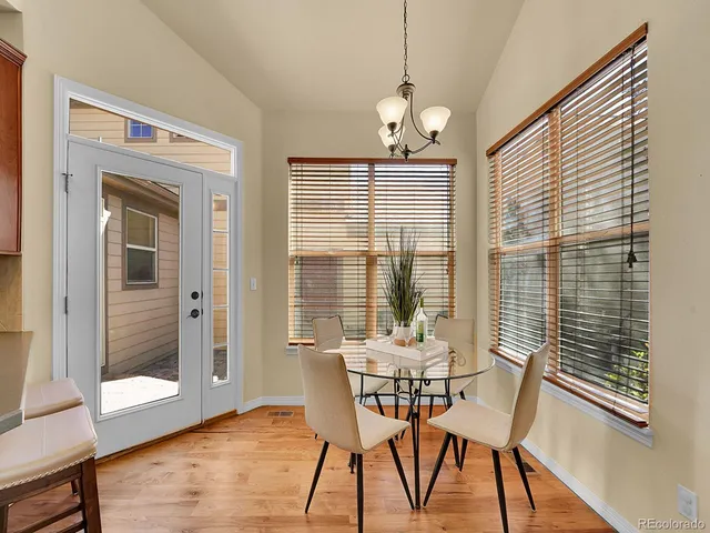 a dining room with furniture window and wooden floor