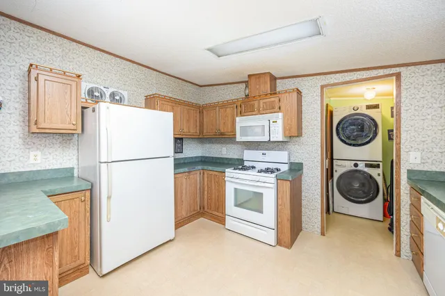 a kitchen with a refrigerator sink and stove top oven