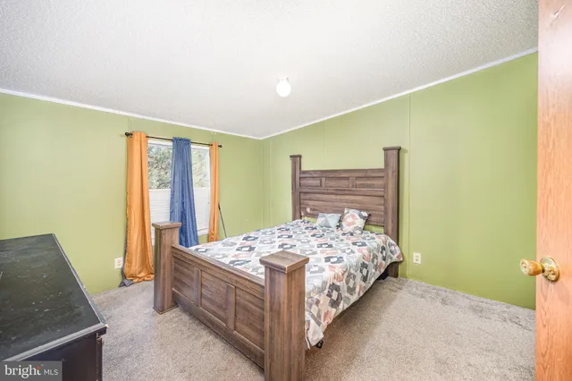 a room that has a bed and a dresser