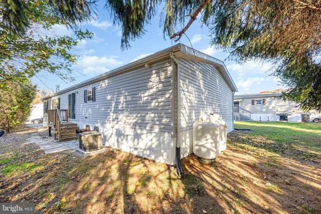 a view of a house with backyard and a tree