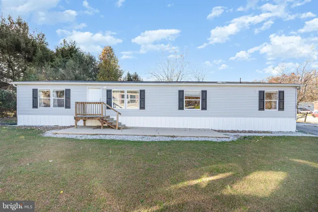 a view of a house with swimming pool and a yard