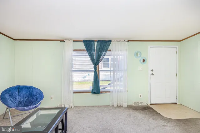 an empty room with a fireplace and painted walls