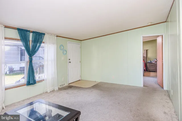 a view of empty room with a fireplace
