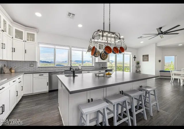 a kitchen with stainless steel appliances kitchen island granite countertop a sink and cabinets