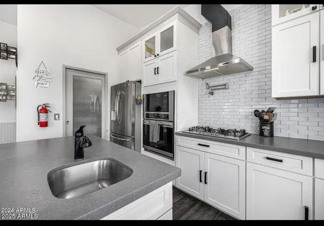 a kitchen with cabinets a sink and appliances
