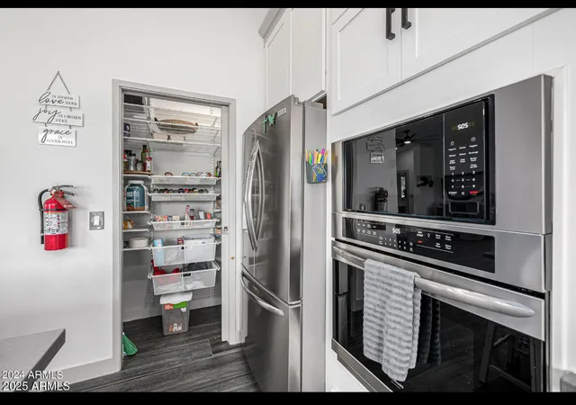 a kitchen with stainless steel appliances a refrigerator and a stove