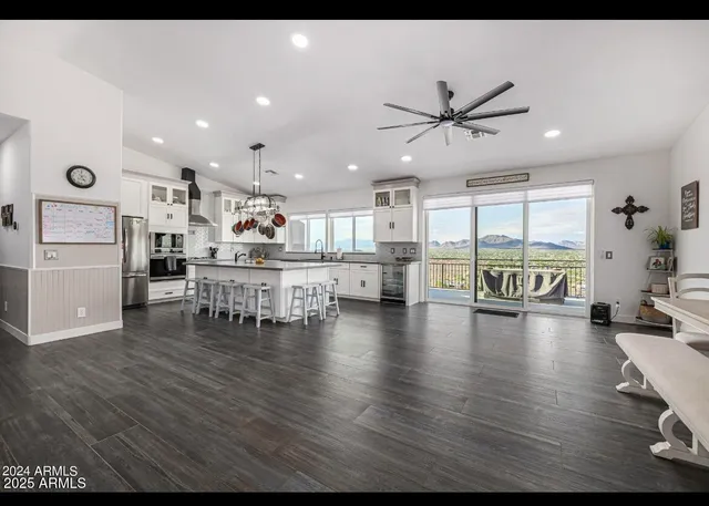 a living room with furniture and kitchen view
