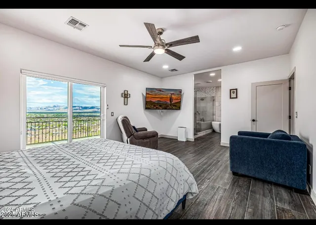 a bedroom with a bed couch and window