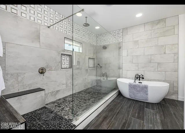 a bathroom with a sink shower and mirror