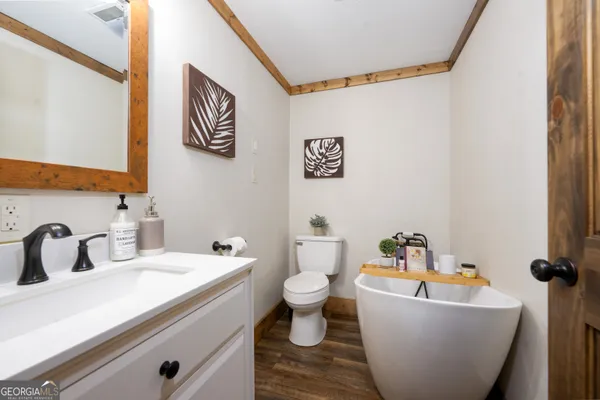 a bathroom with a sink and mirror with toilet