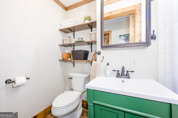 a bathroom with a sink a toilet and mirror
