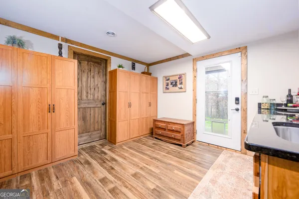 a view of a bedroom with wooden floor and a window