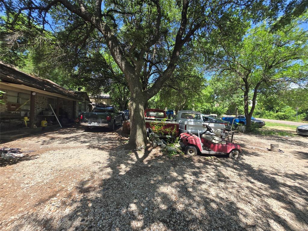 5082 Bennett Road Wylie, TX 75098 - Photo 2 of 26 a view of backyard with table and chairs and a large tree