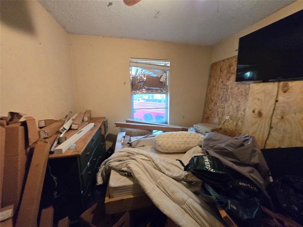 5082 Bennett Road Wylie, TX 75098 - Photo 24 of 26 a bedroom with a bed and a flat screen tv