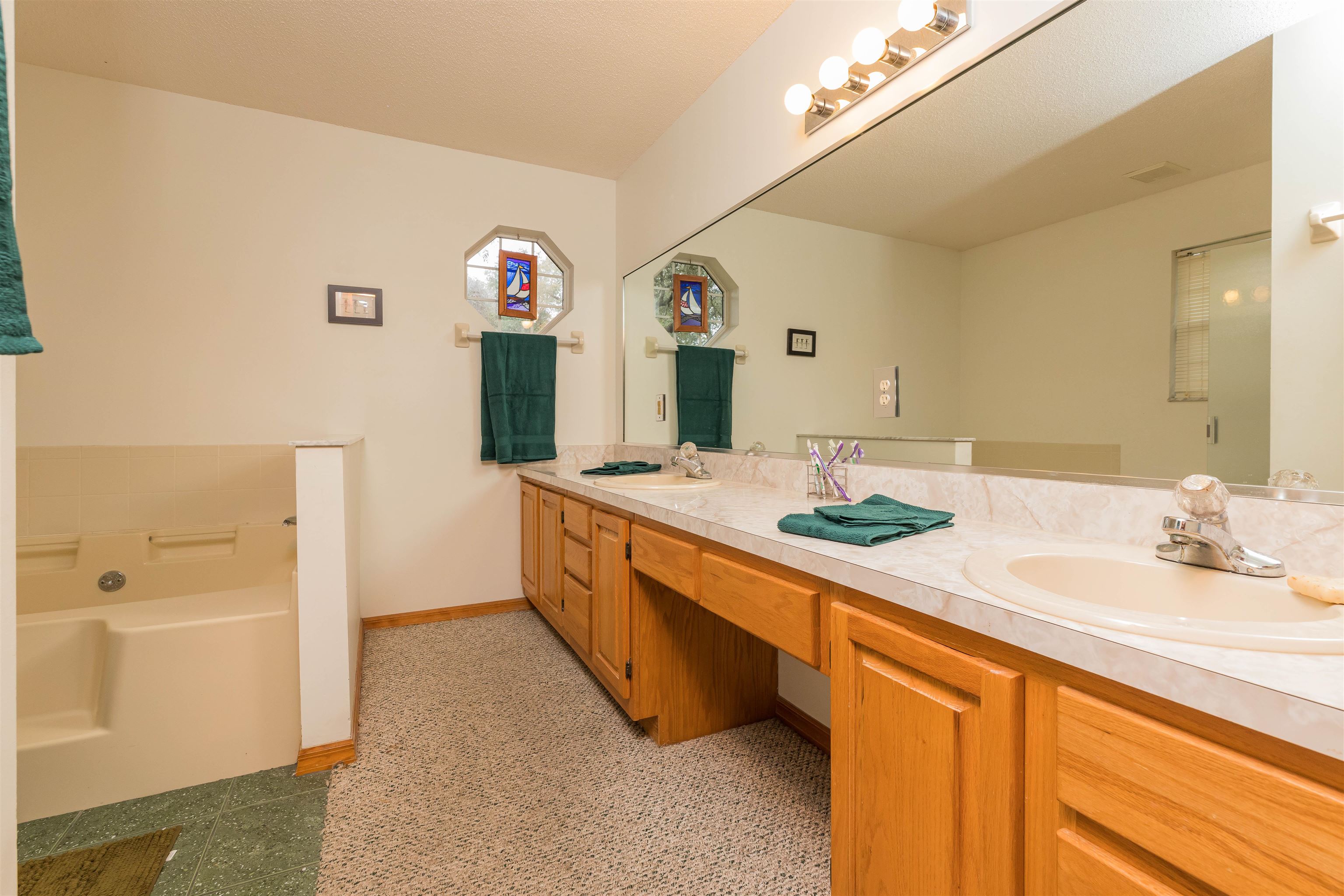 3224 Turtle Creek Road St. Augustine, FL 32086 - Photo 23 of 44 a spacious bathroom with a double vanity sink a mirror and a bathtub