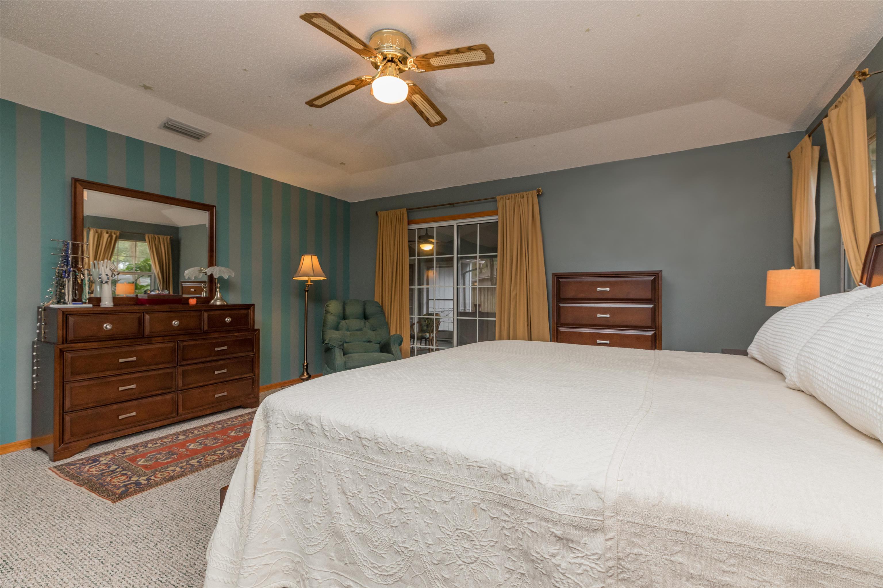 3224 Turtle Creek Road St. Augustine, FL 32086 - Photo 27 of 44 a bedroom with a bed and a dresser