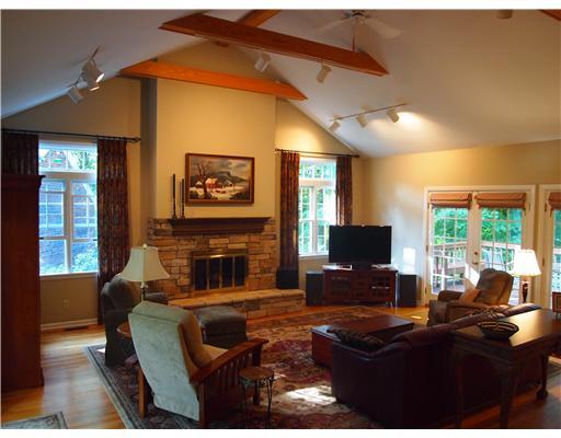504 Beaver Road Edgeworth, PA 15143 - Photo 6 of 18 Family Room. cathedral ceiling, beamed, hardwood floors, three sets of doors to exterior deck or covered porch, stone fireplace, adjacent to the kitchen, dining room, and deck