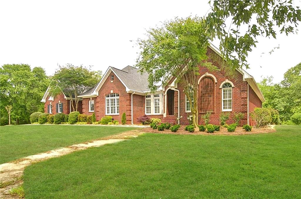 299 Floyd Road Northeast Calhoun, GA 30701 - Photo 1 of 1 a front view of a house with a garden