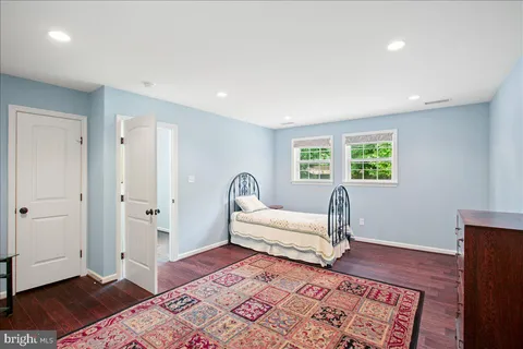 a spacious bedroom with a bed and a window