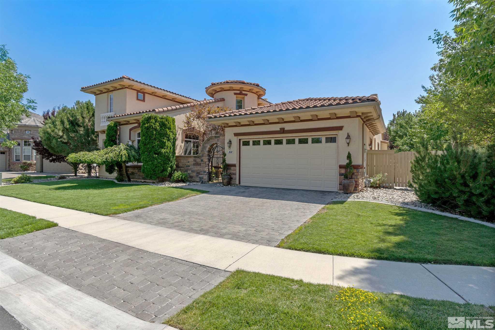 a front view of a house with a yard and a garage