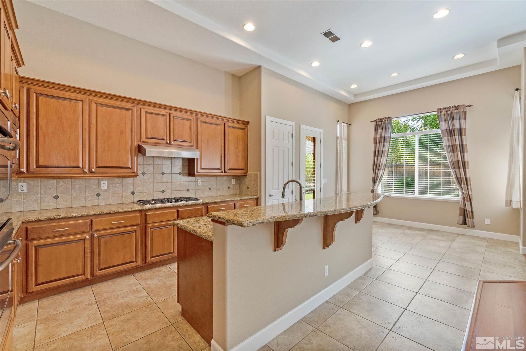 2630 Strathmore Court Reno, NV 89521 - Photo 11 of 40 a kitchen with stainless steel appliances granite countertop a sink and cabinets