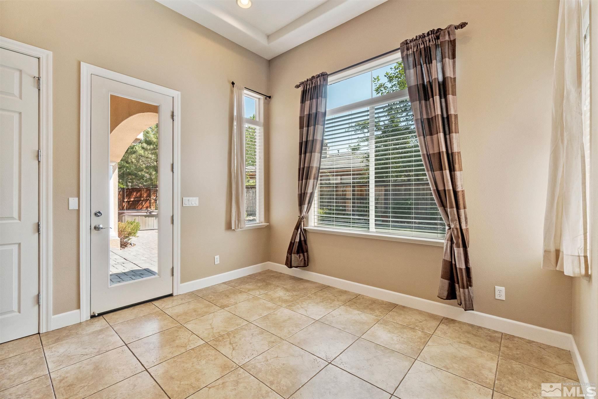 2630 Strathmore Court Reno, NV 89521 - Photo 12 of 40 a view of an empty room with wooden floor and a window