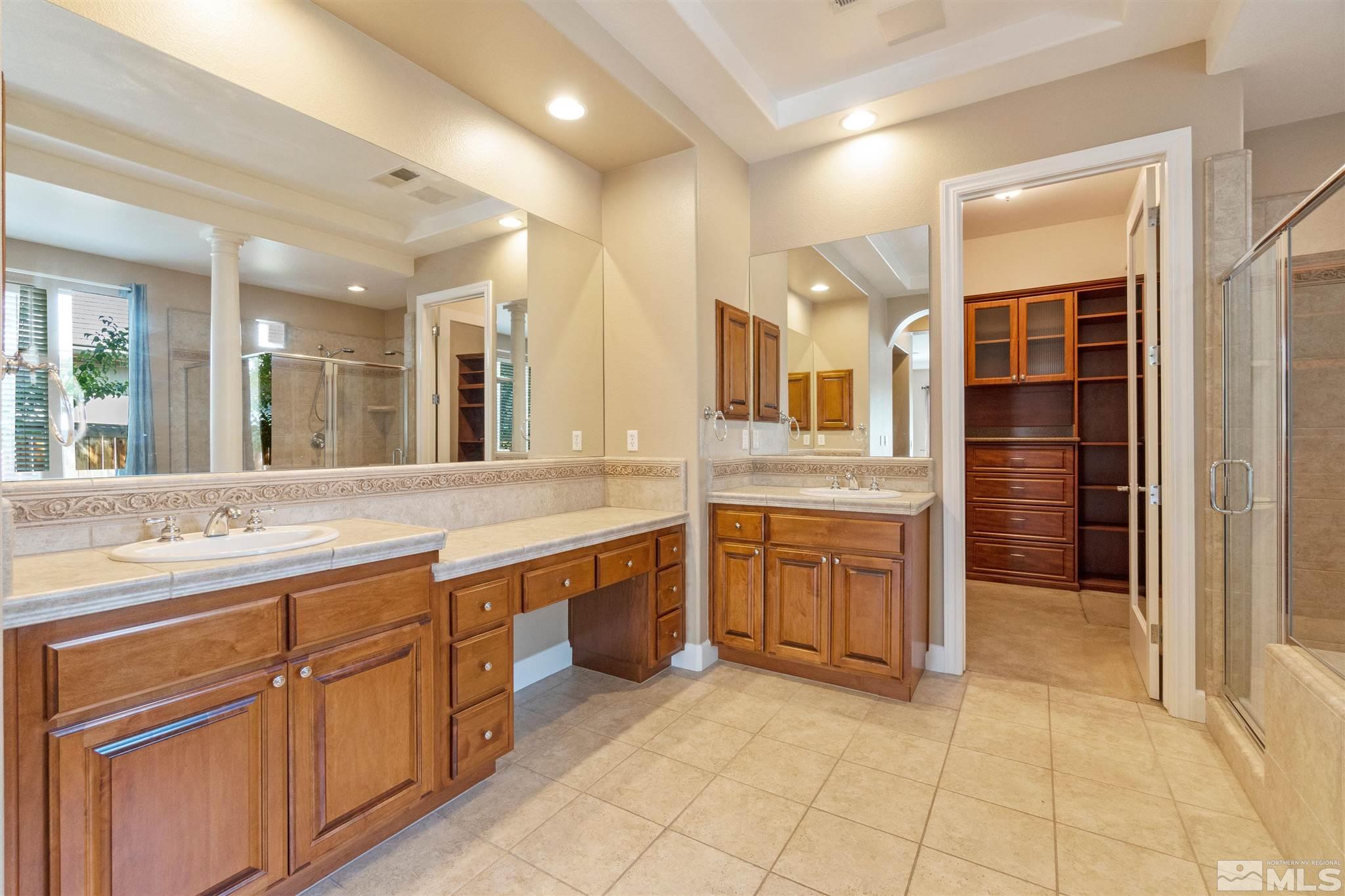 2630 Strathmore Court Reno, NV 89521 - Photo 16 of 40 a large bathroom with a large mirror vanity and a sink
