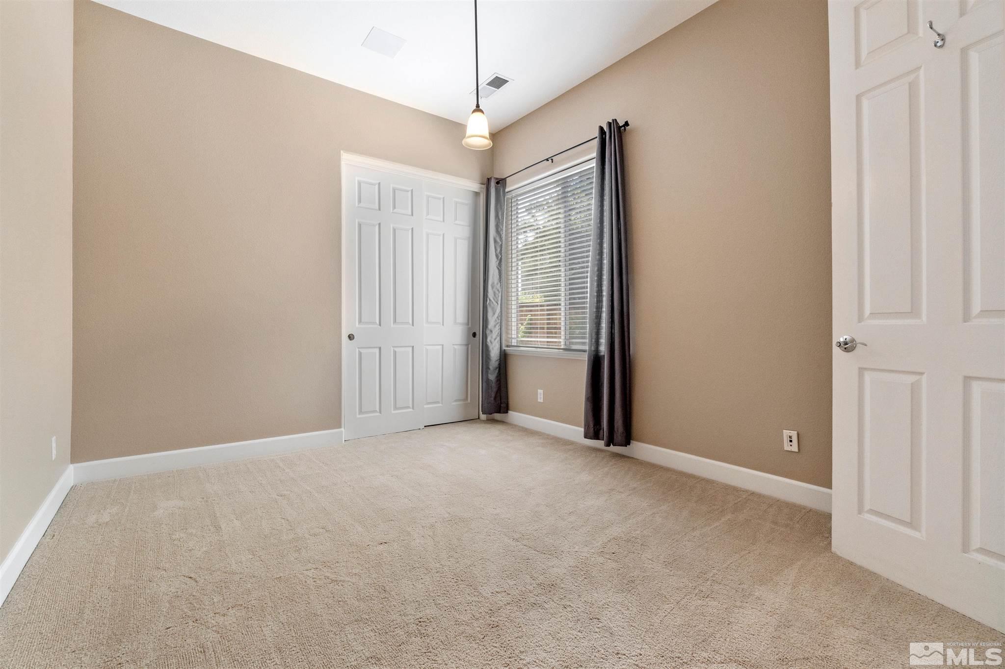 2630 Strathmore Court Reno, NV 89521 - Photo 20 of 40 an empty room with windows and chandelier fan