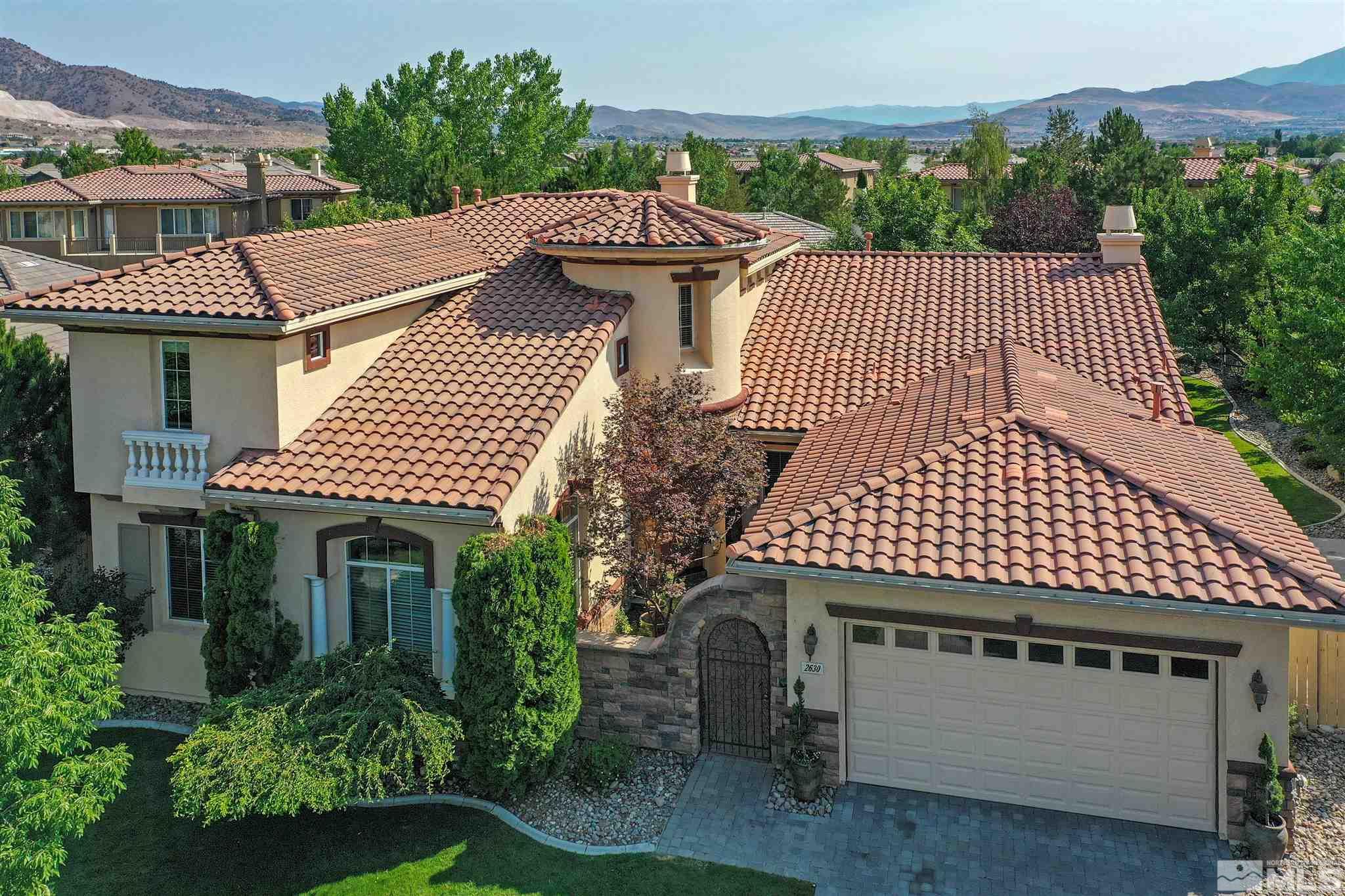 2630 Strathmore Court Reno, NV 89521 - Photo 2 of 40 a front view of a house with a garden