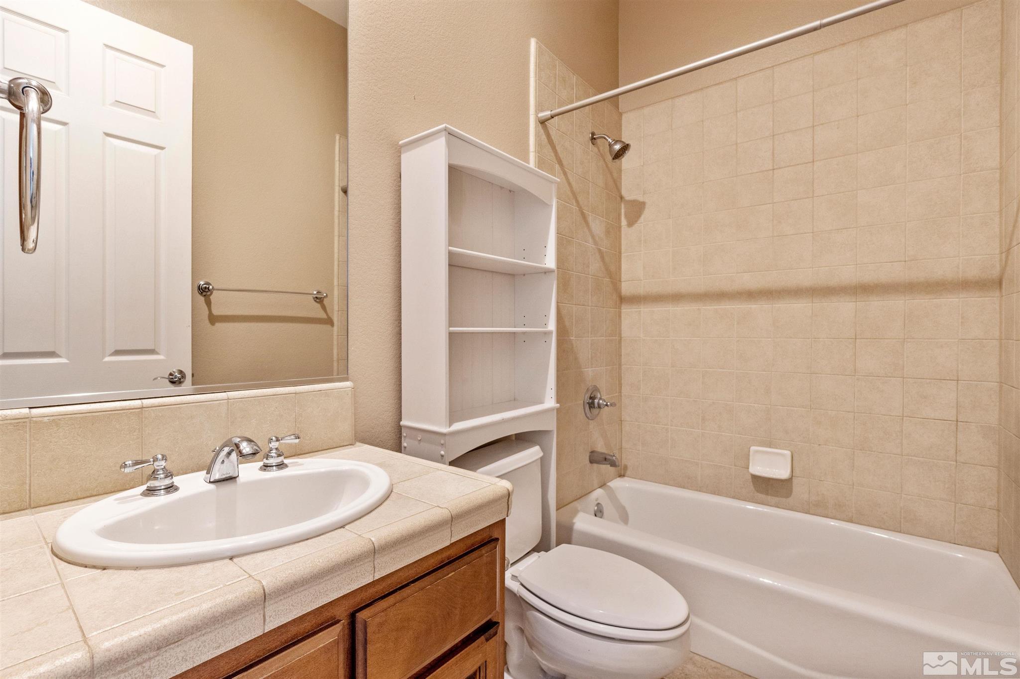 2630 Strathmore Court Reno, NV 89521 - Photo 21 of 40 a bathroom with a sink toilet vanity and shower