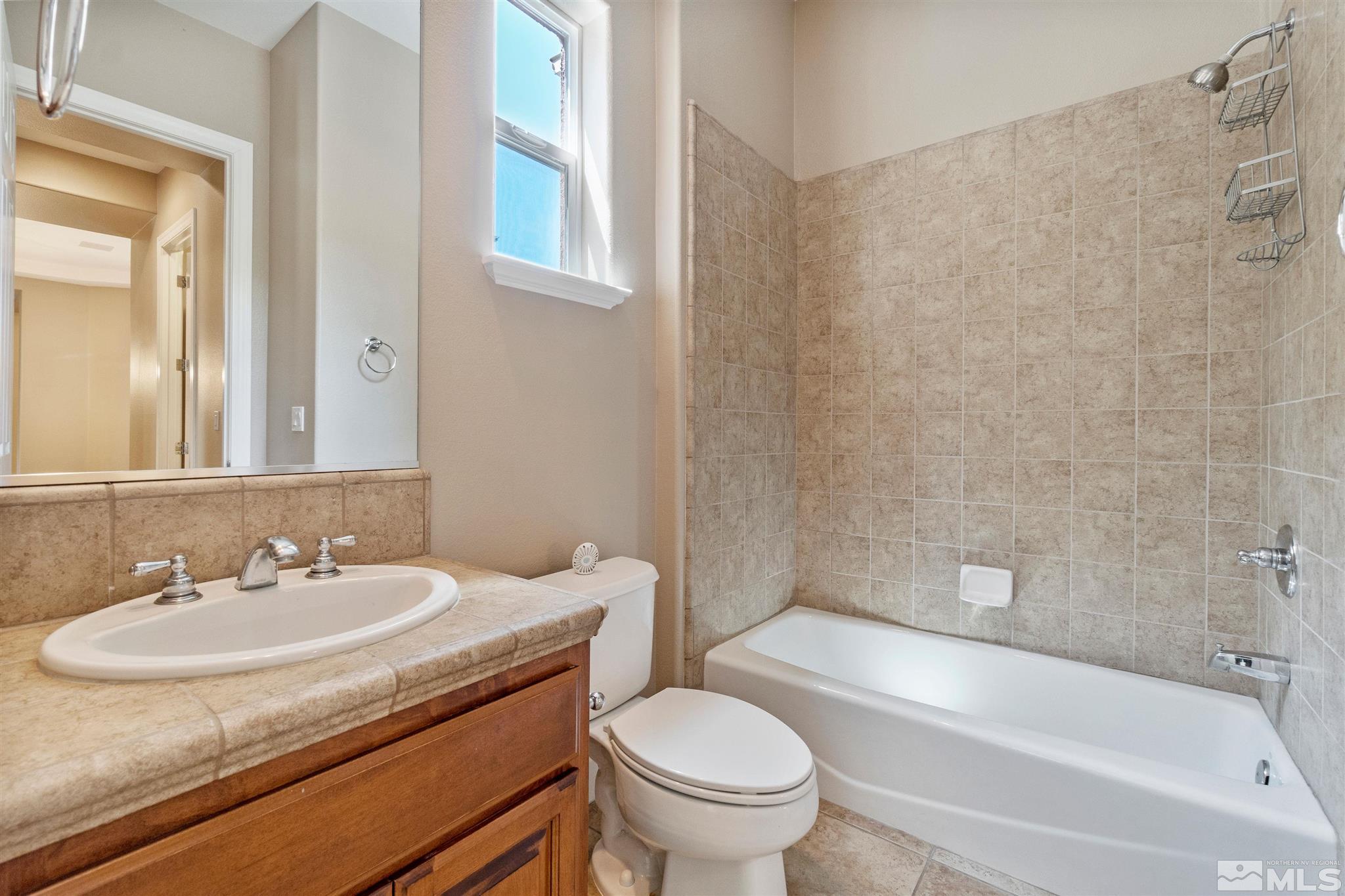 2630 Strathmore Court Reno, NV 89521 - Photo 22 of 40 a bathroom with a sink toilet and shower