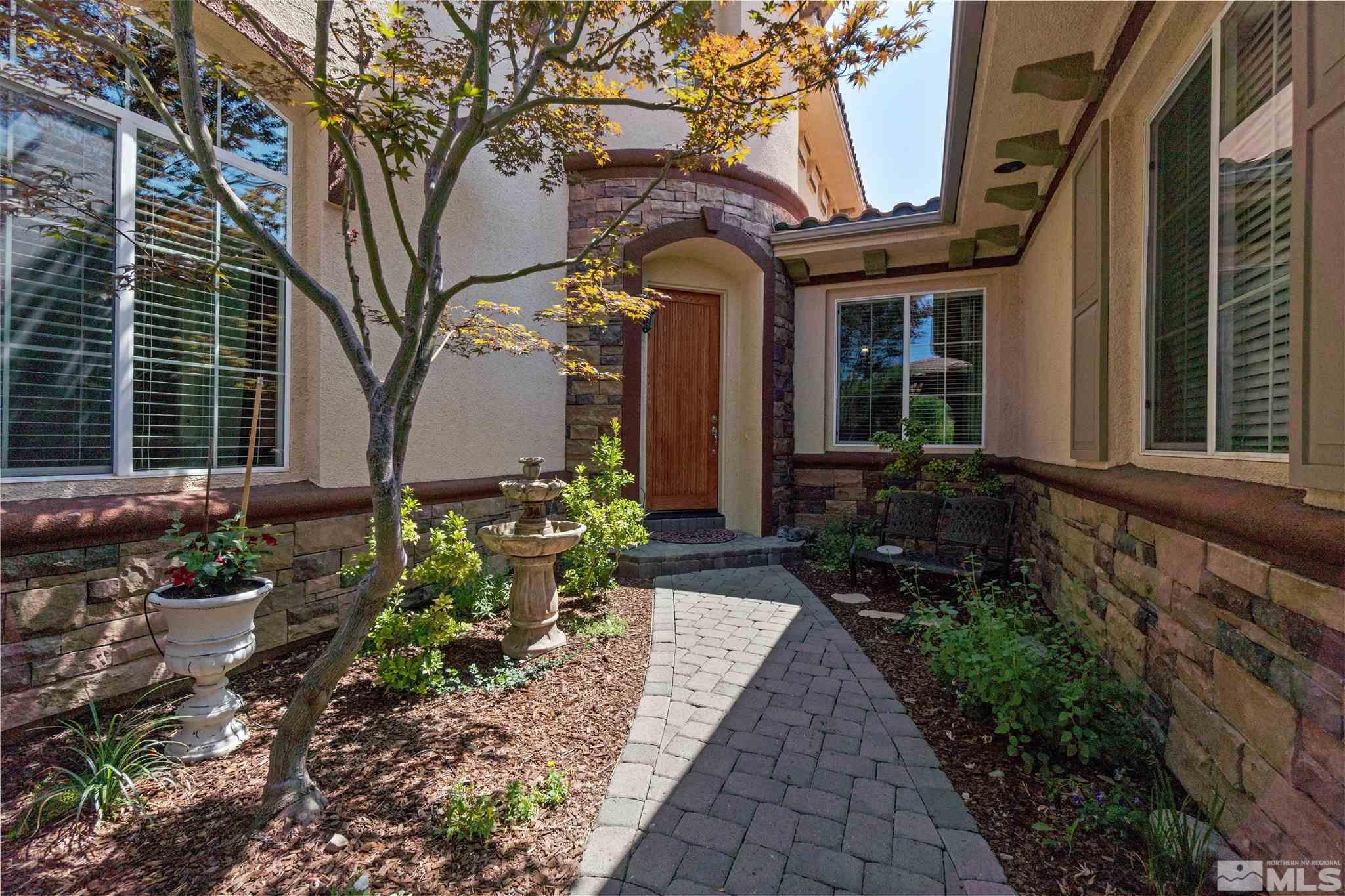 2630 Strathmore Court Reno, NV 89521 - Photo 3 of 40 a front view of a house with a garden