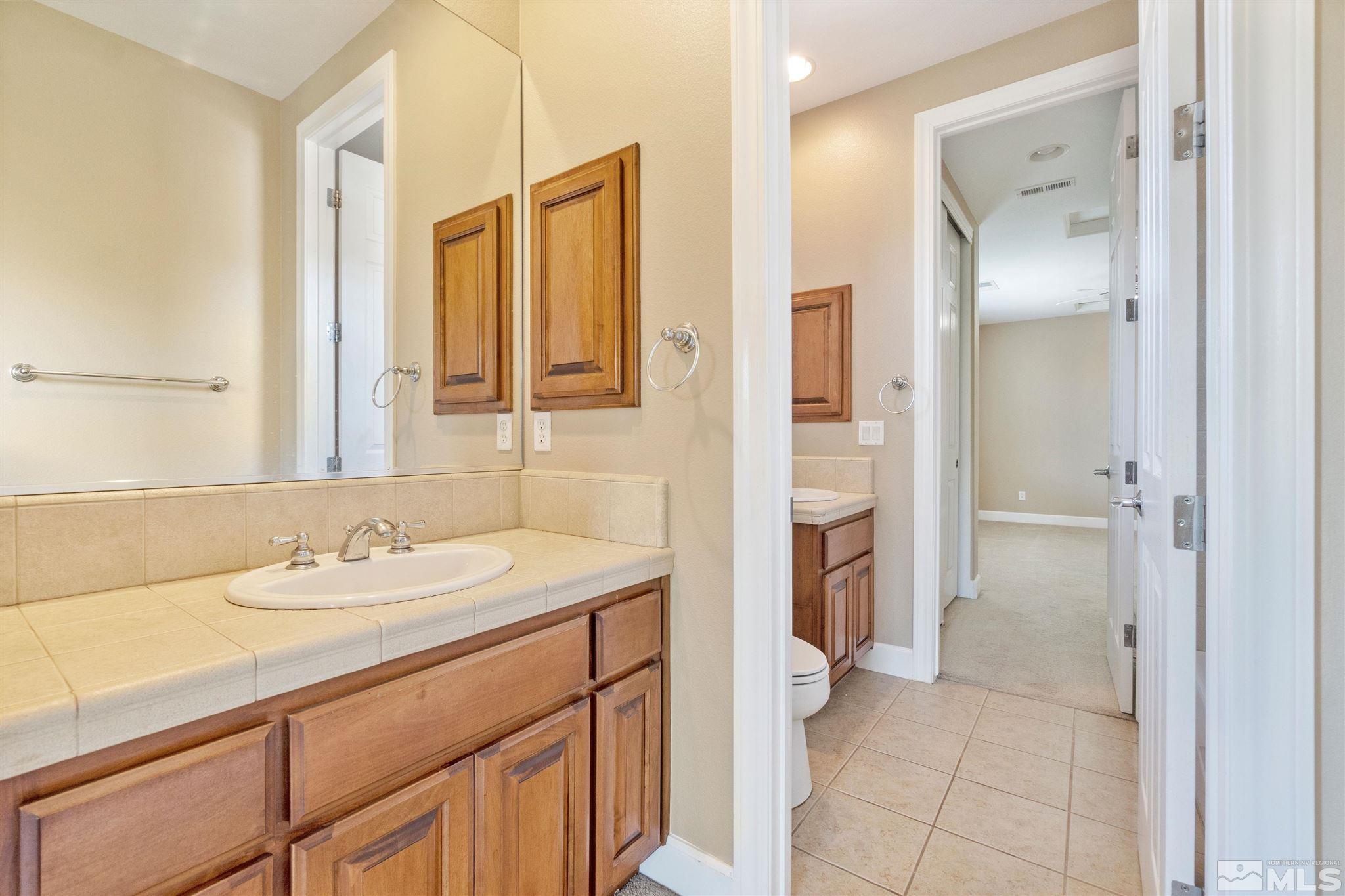 2630 Strathmore Court Reno, NV 89521 - Photo 32 of 40 a bathroom with a sink and a mirror
